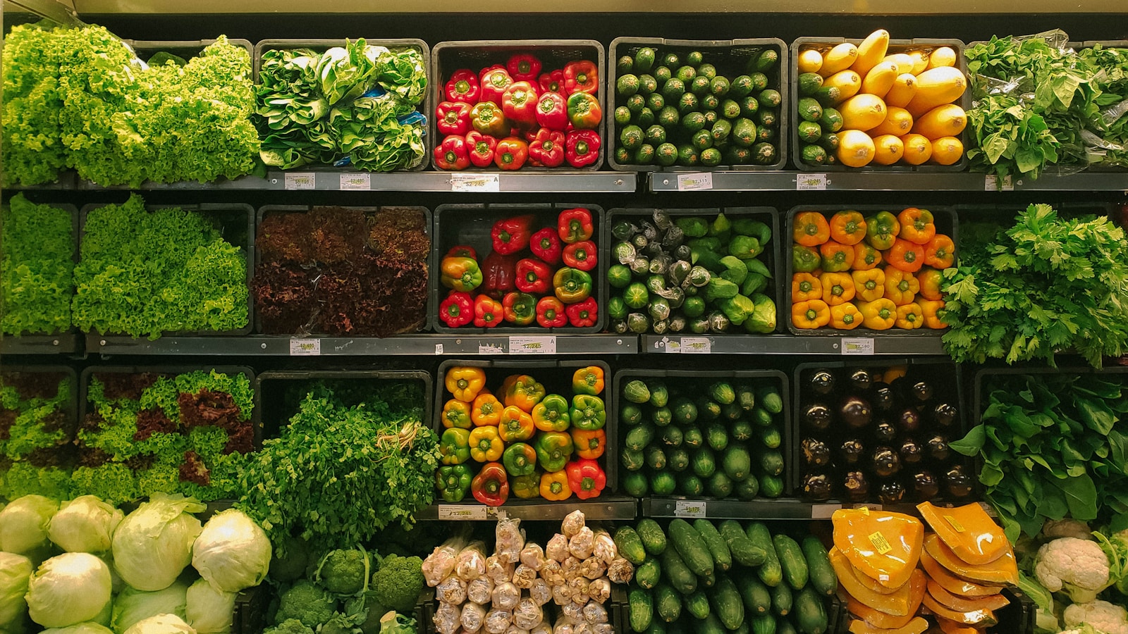 Shopping cart filled with fresh produce in a supermarket