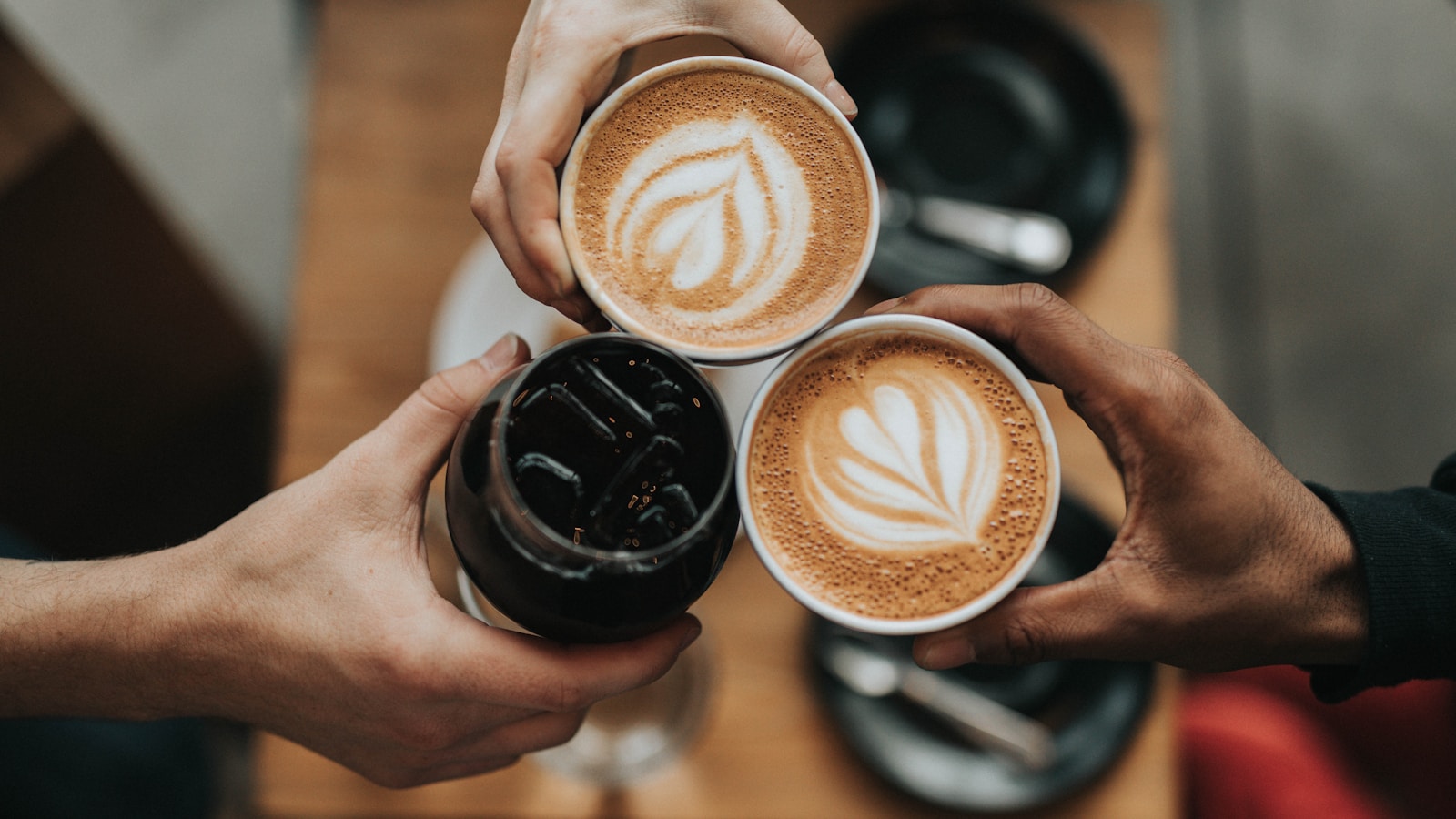 Latte art on a flat white in a sunlit specialty coffee shop