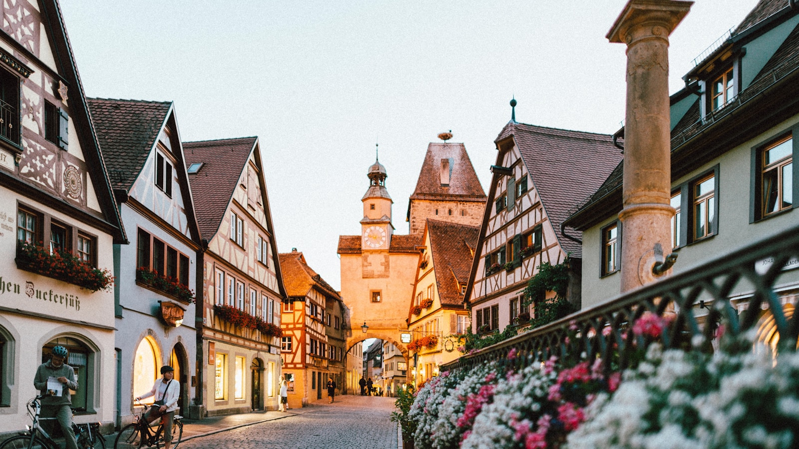 European city square at golden hour with cafes and historic buildings