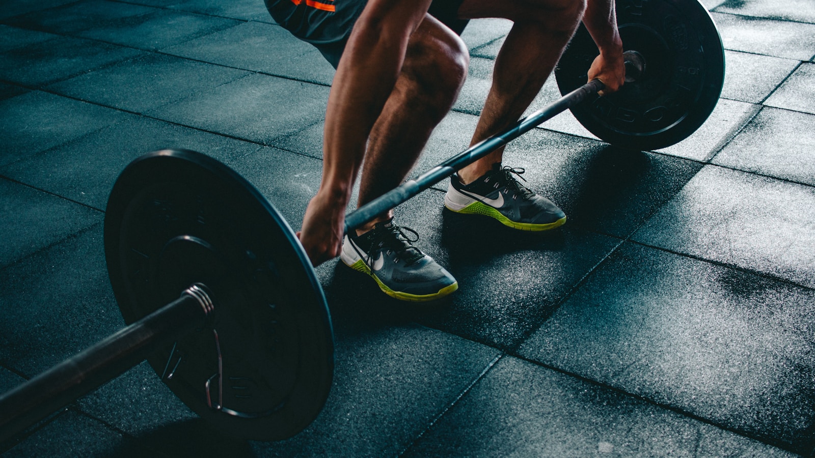 Workout shoes and a small kettlebell ready on a wooden floor