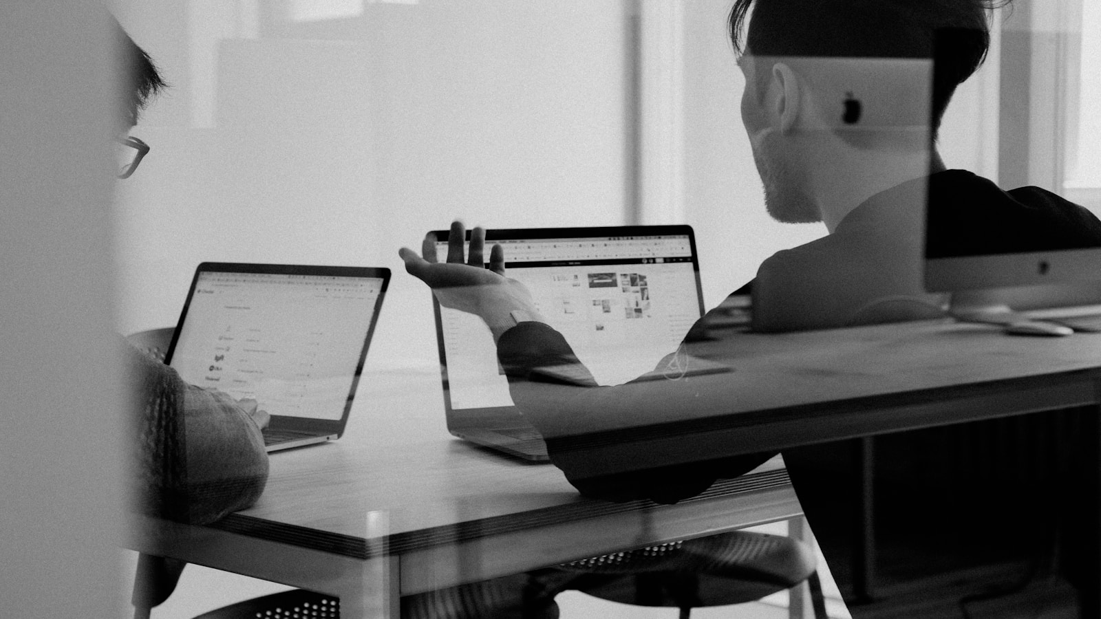 Calm meeting between two professionals across a small desk