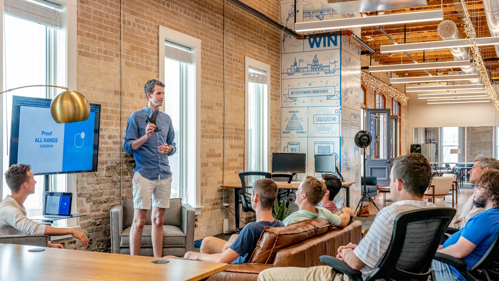 Speaker addressing a small audience confidently in a bright conference room