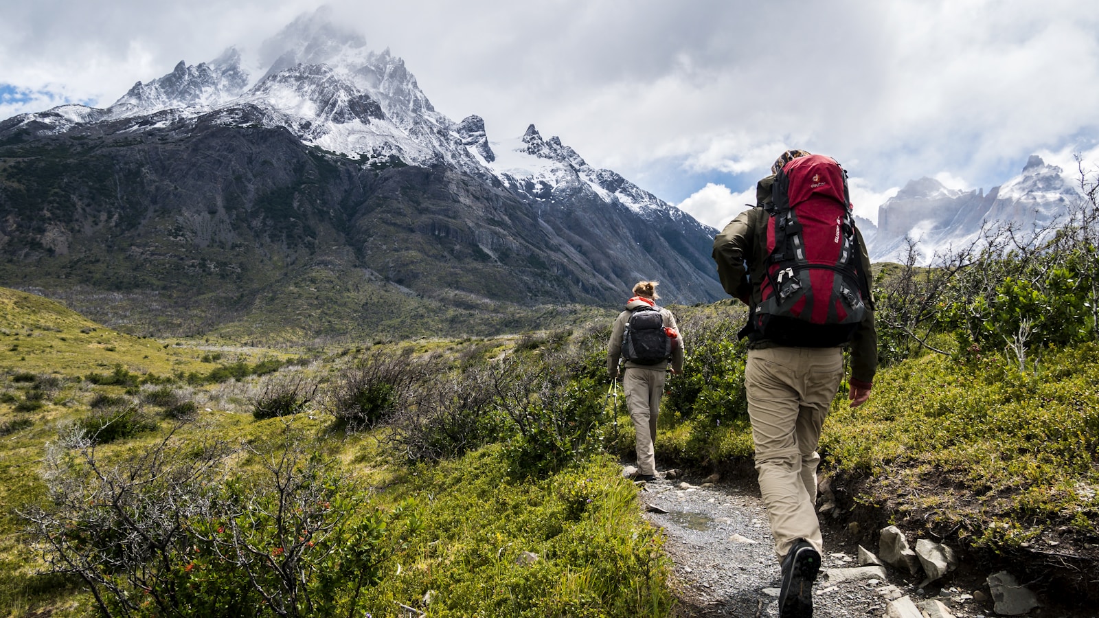 Hiker on a quiet wooded trail with a small backpack