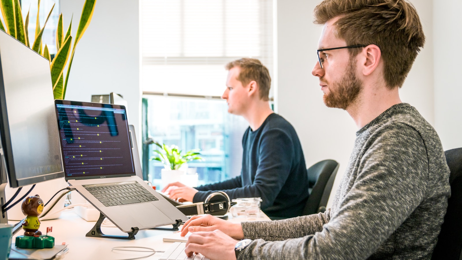 Product manager and engineer reviewing a spec document on a laptop